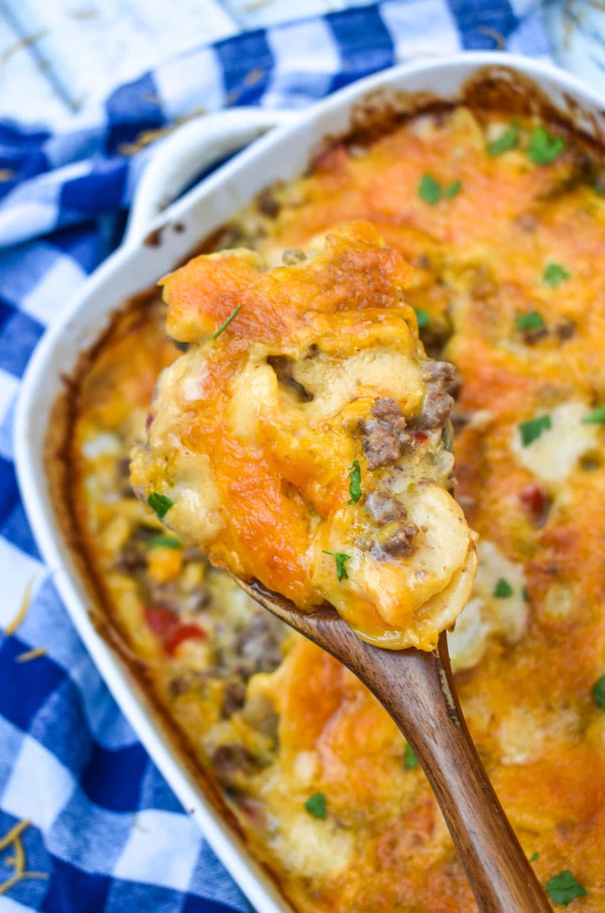 a wooden spoon holding up a scoop of hobo casserole