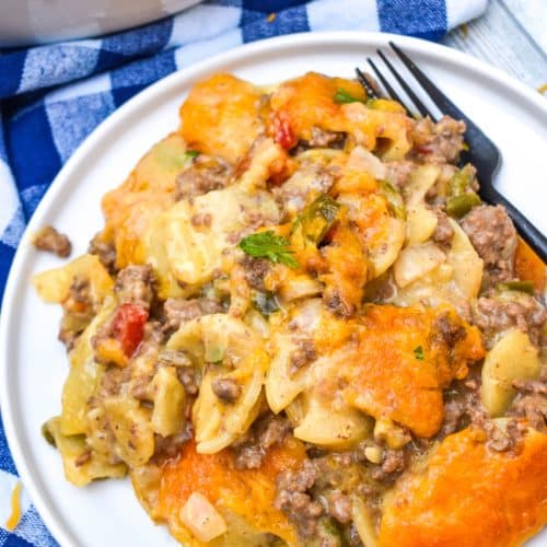 hobo casserole on a white plate with a black fork resting on the side