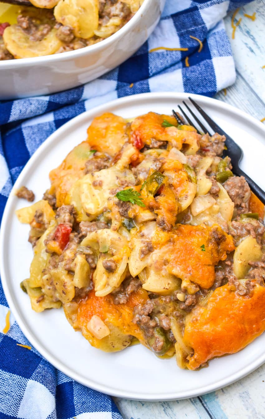 hobo casserole on a white plate with a black fork resting on the side