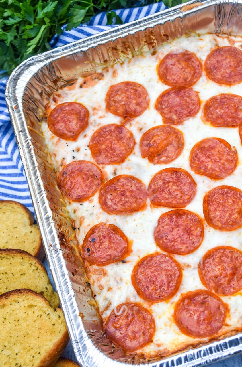 smoked pepperoni pizza dip in an aluminum tray