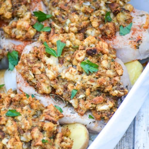 Baked Pork Chops With Stuffing And Apples in a white casserole dish