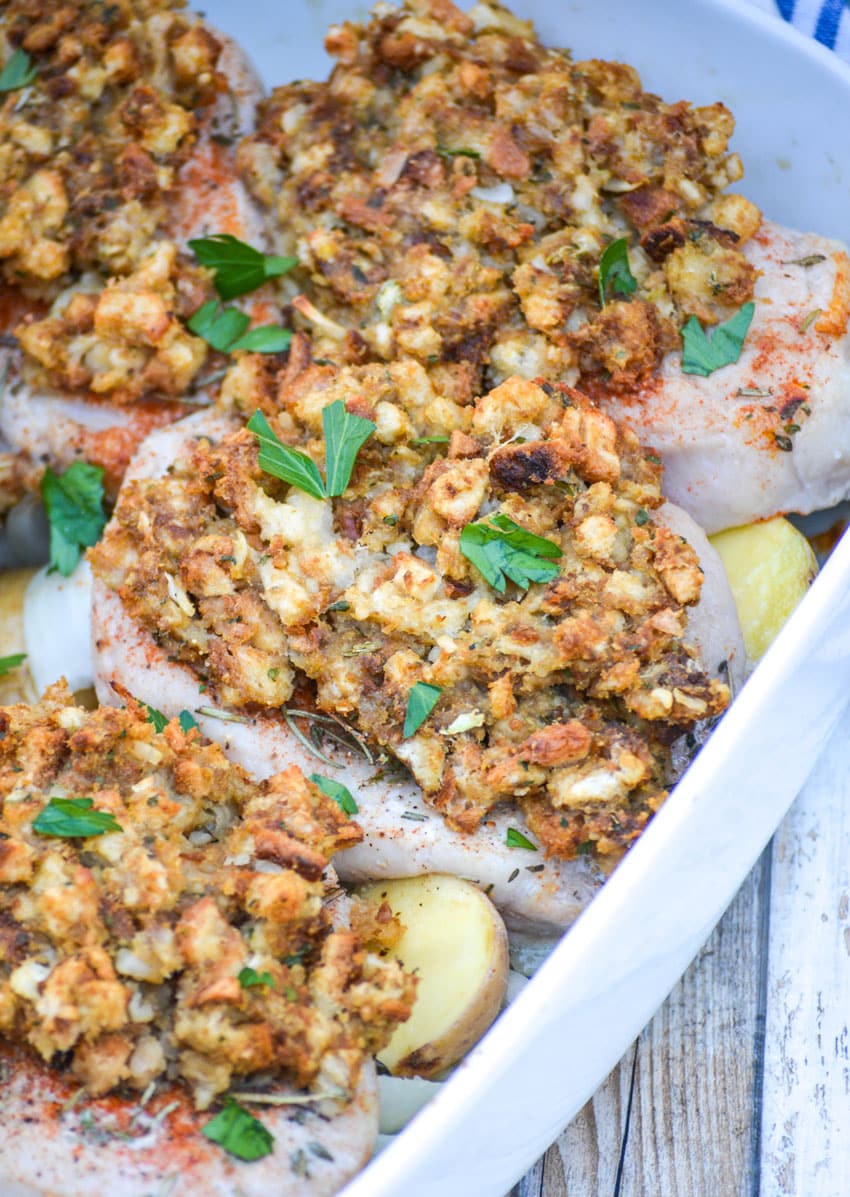 Baked Pork Chops With Stuffing And Apples in a white casserole dish