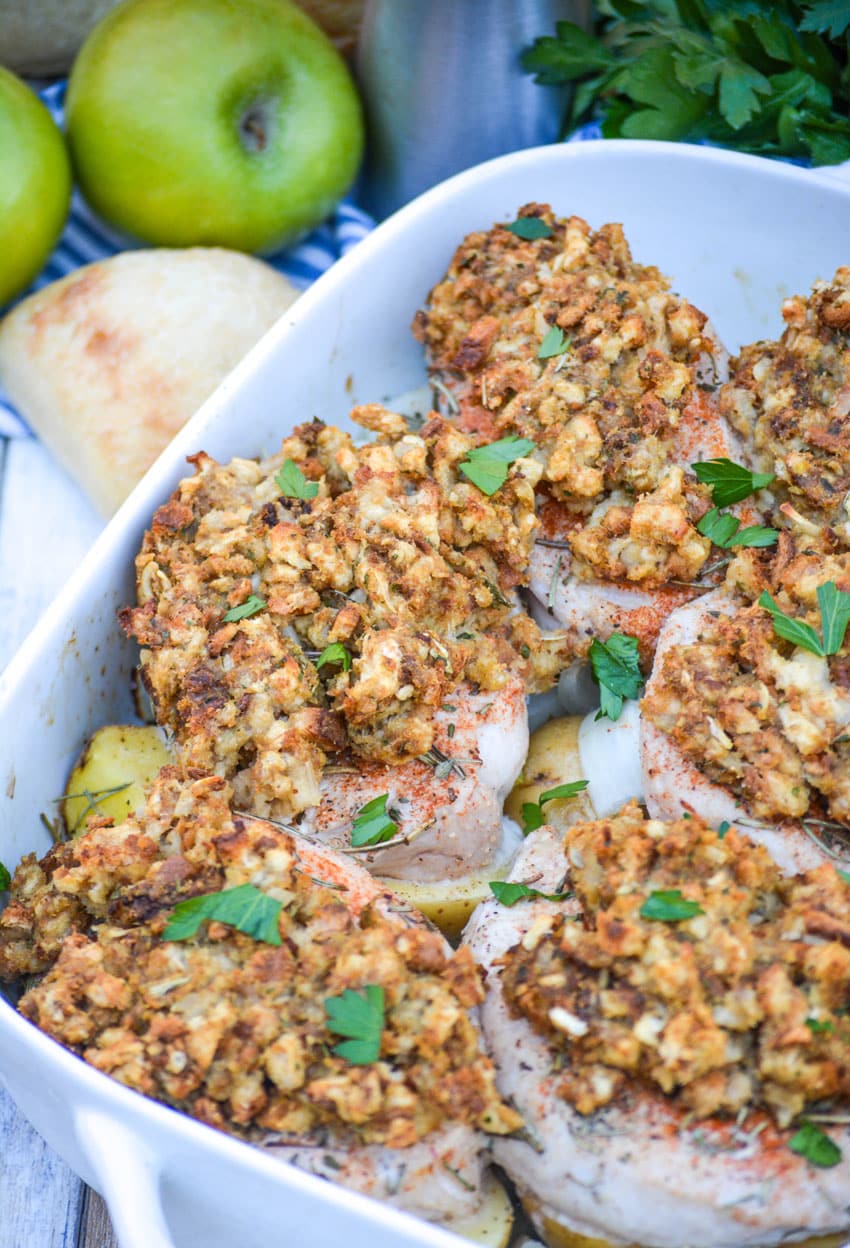 Baked Pork Chops With Stuffing And Apples in a white casserole dish