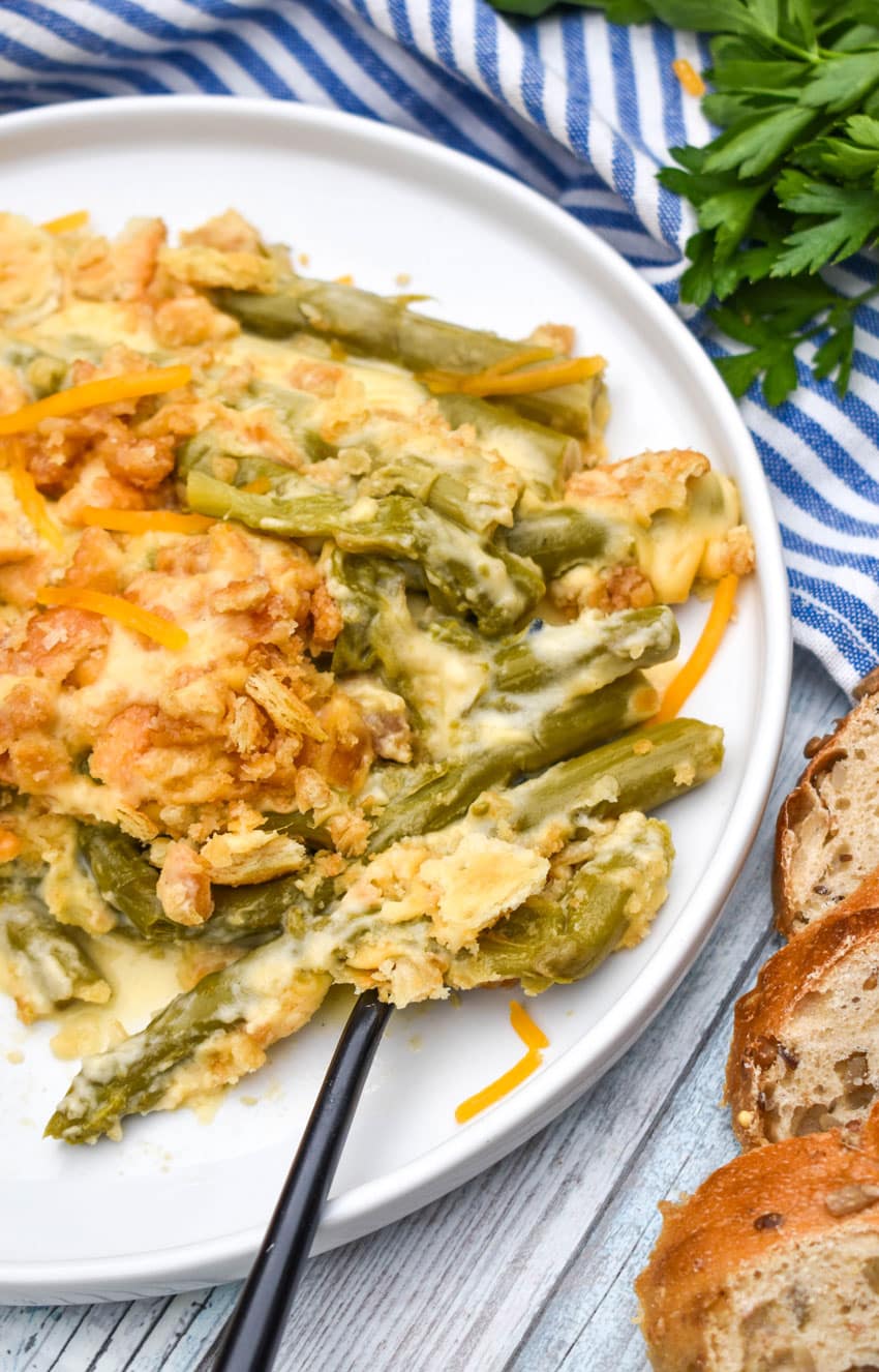 cheesy asparagus casserole served on a white plate