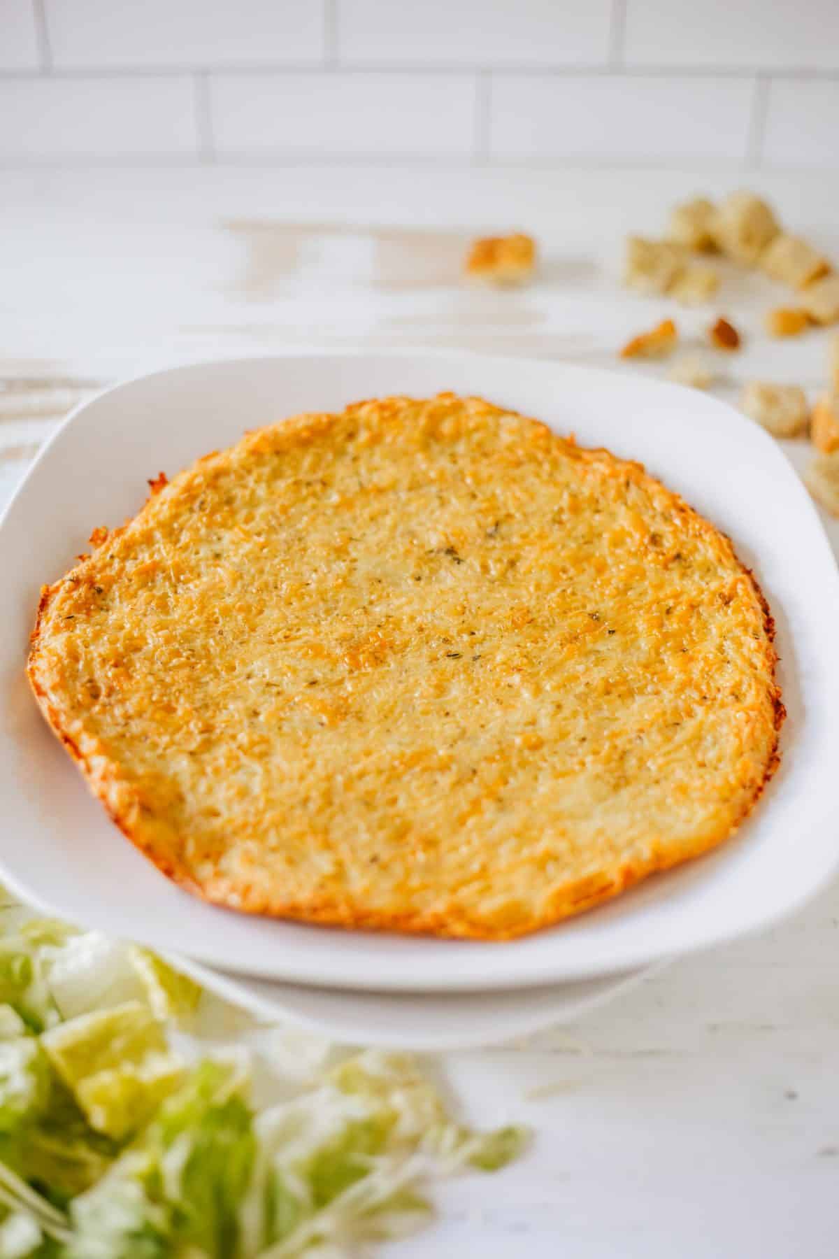 a baked chicken pizza crust on a white plate
