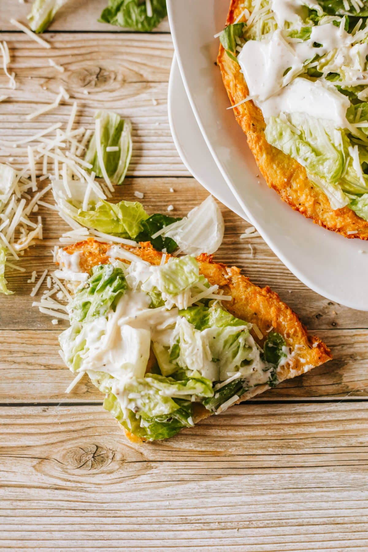 a slice of tiktok caesar chicken pizza on a wooden table
