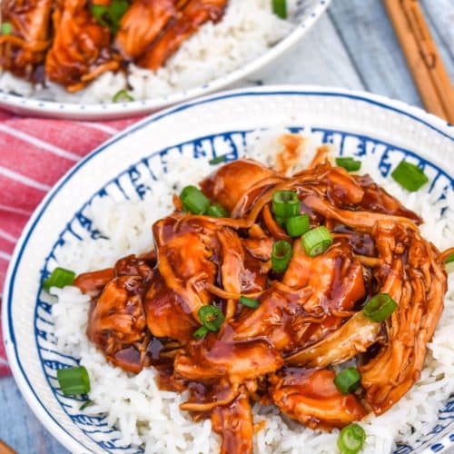 instant pot teriyaki chicken over steamed white rice in a white bowl