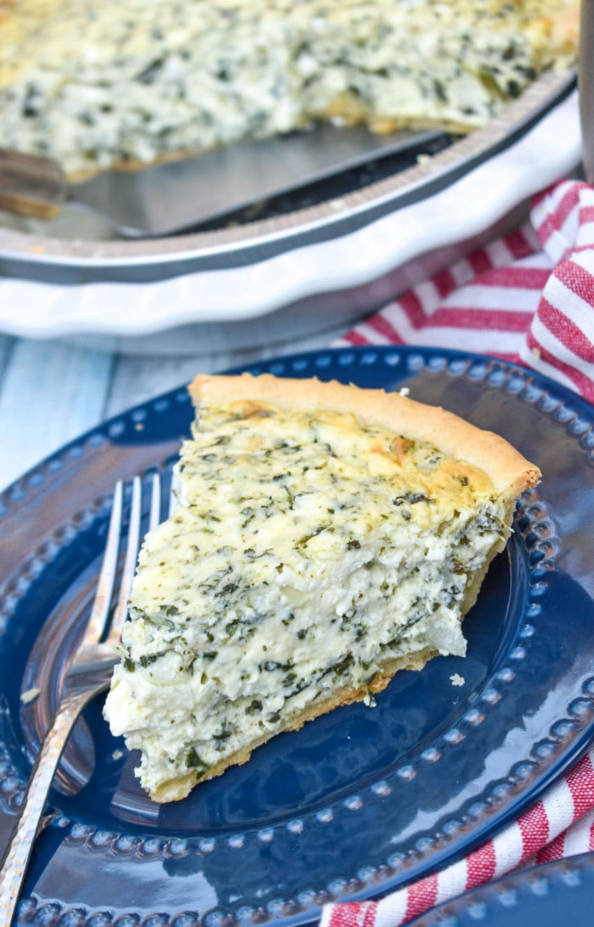 a slice of creamed spinach pie on a small blue plate