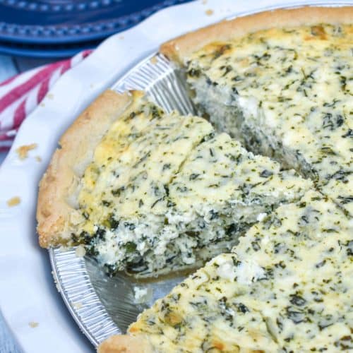 a sliced creamed spinach pie in a white pie plate