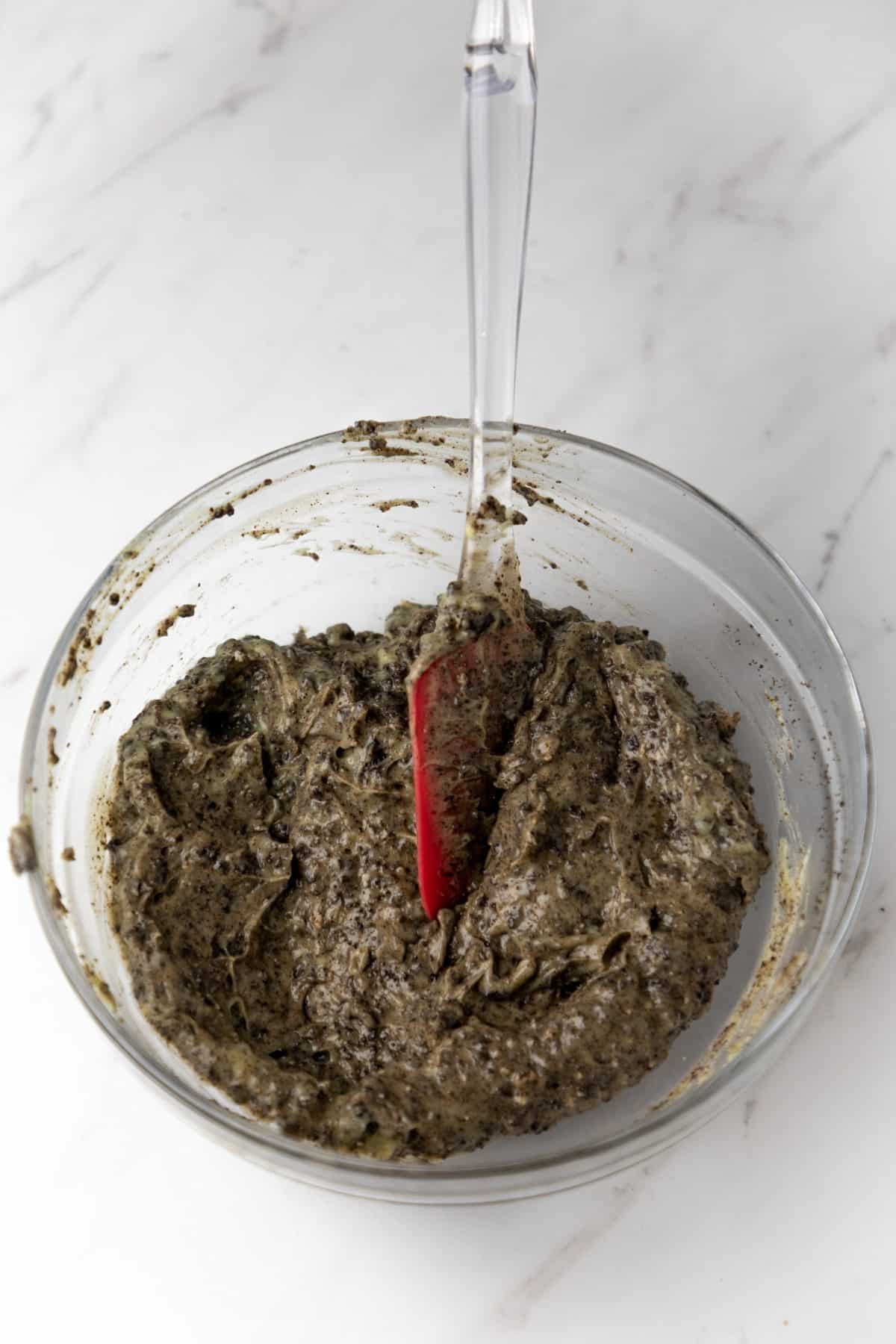 instant vanilla pudding and crushed oreo cookies mixed together in a glass mixing bowl