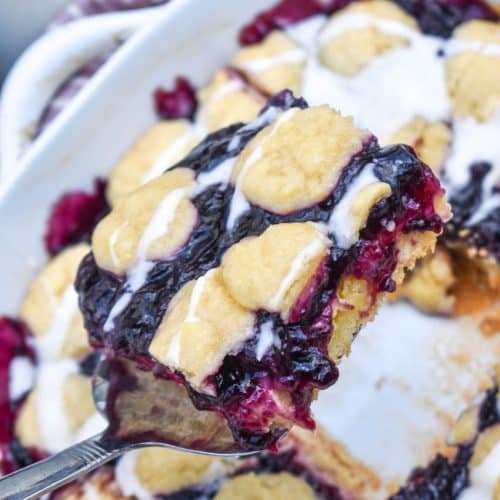 a silver spatula holding up a blueberry pie bar