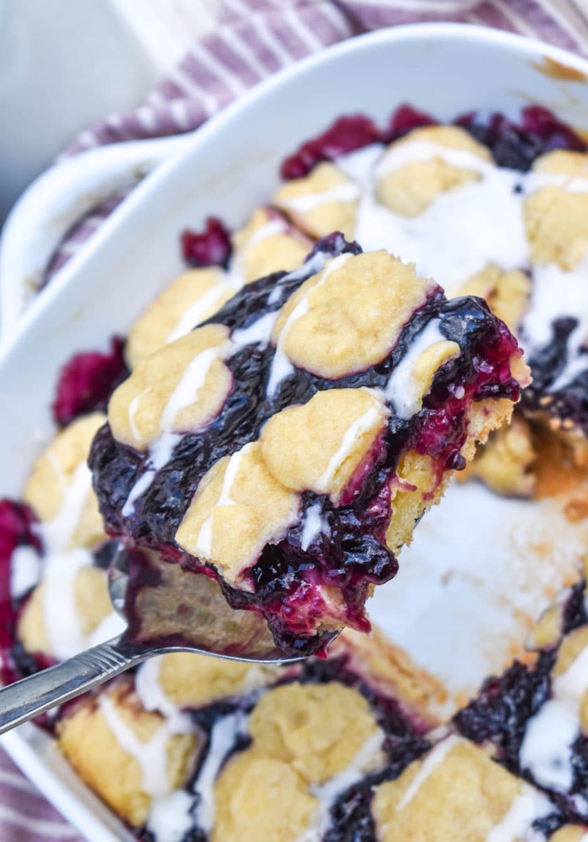 a silver spatula holding up a blueberry pie bar