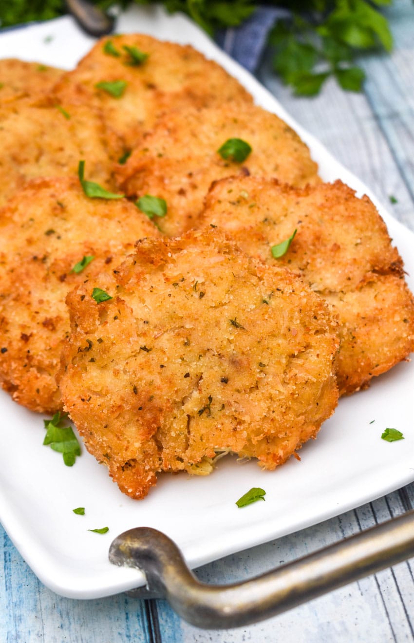 crispy chicken fritters on a white serving plate