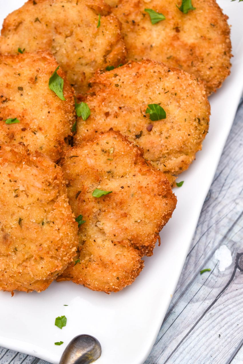 crispy chicken fritters on a white serving plate