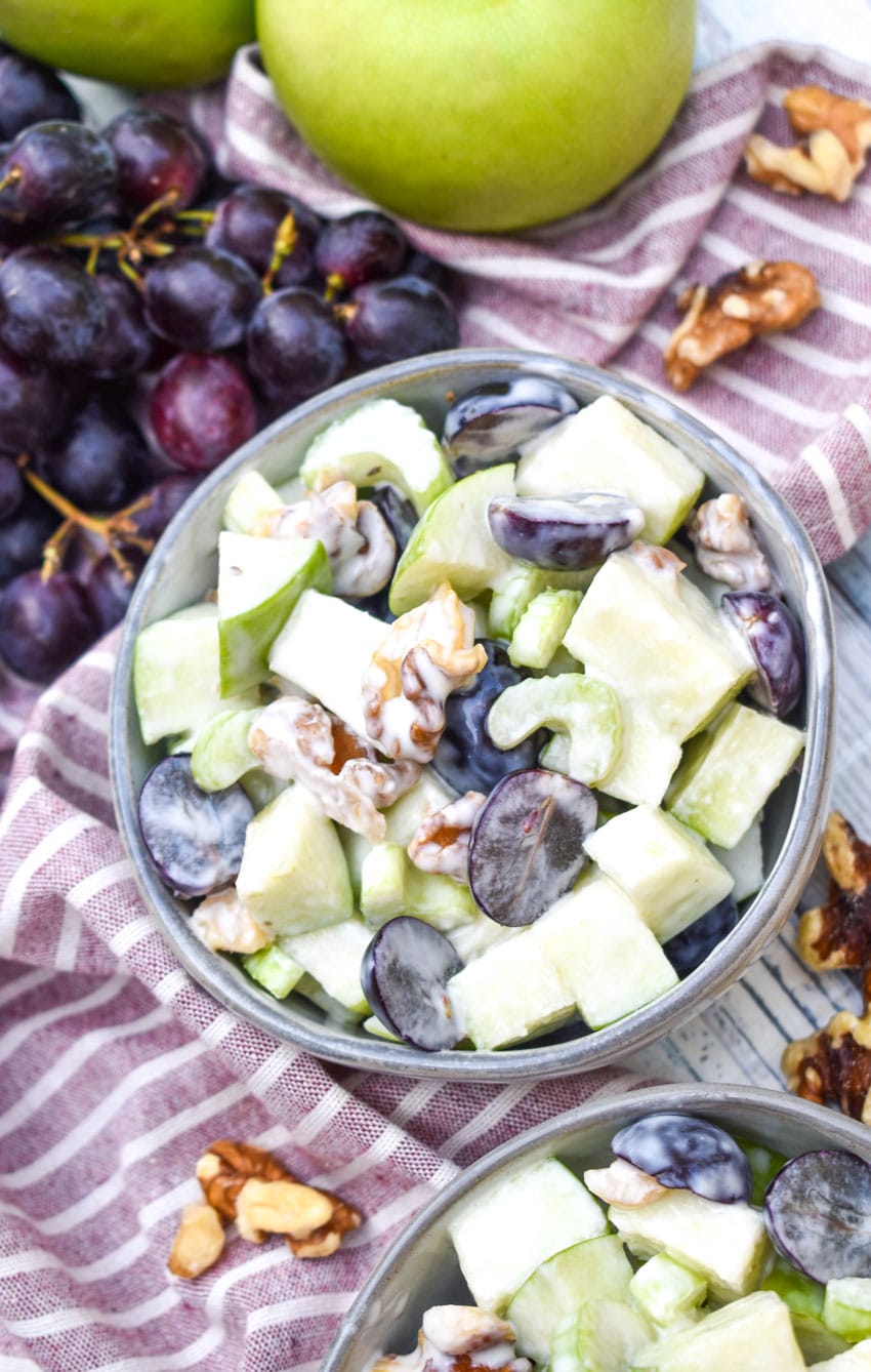 classic waldorf salad in two small gray bowls