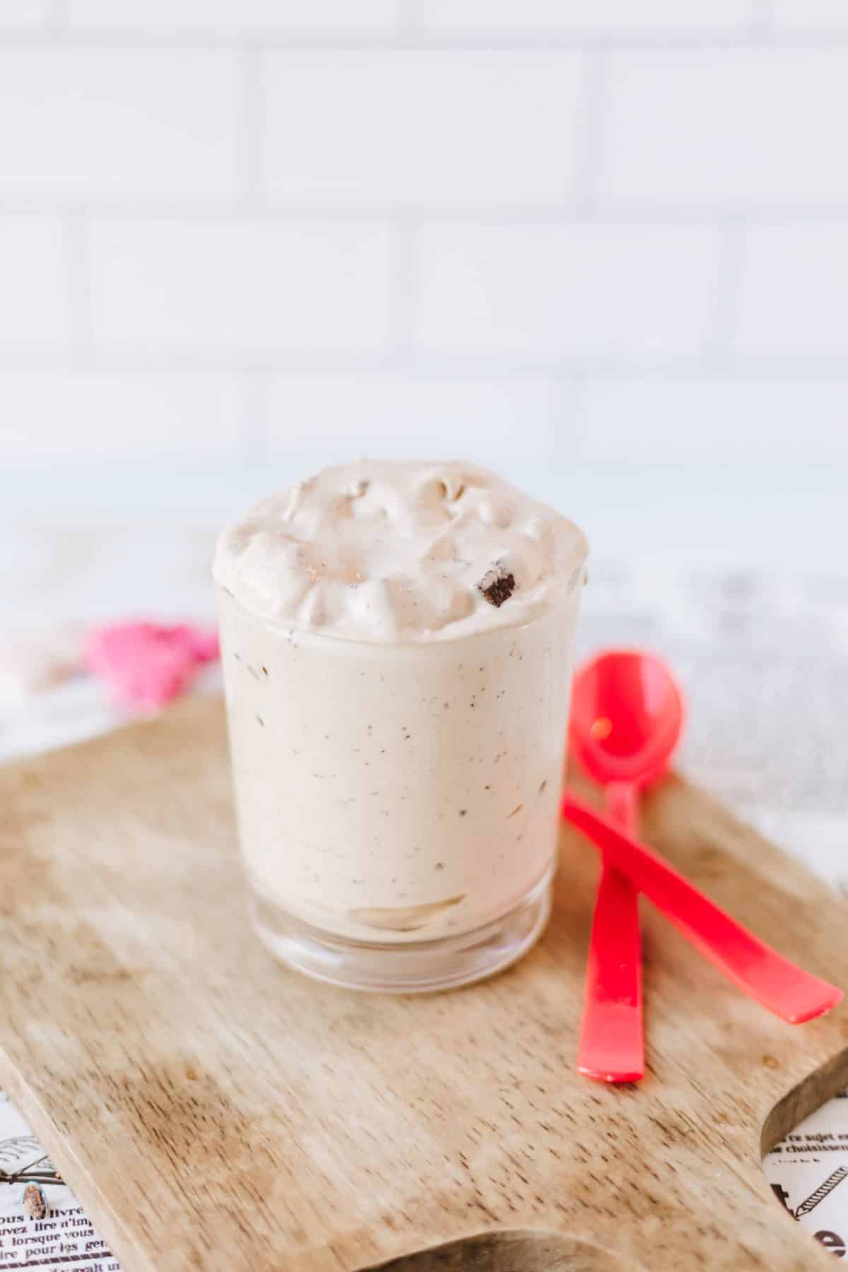 homemade brownie blizzard in a glass on a wooden cutting board