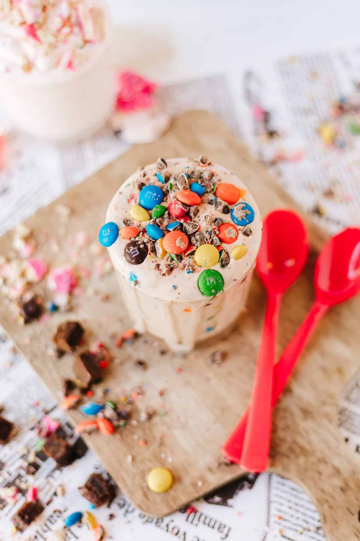 homemade blizzards on a wooden cutting board surrounded by candy pieces