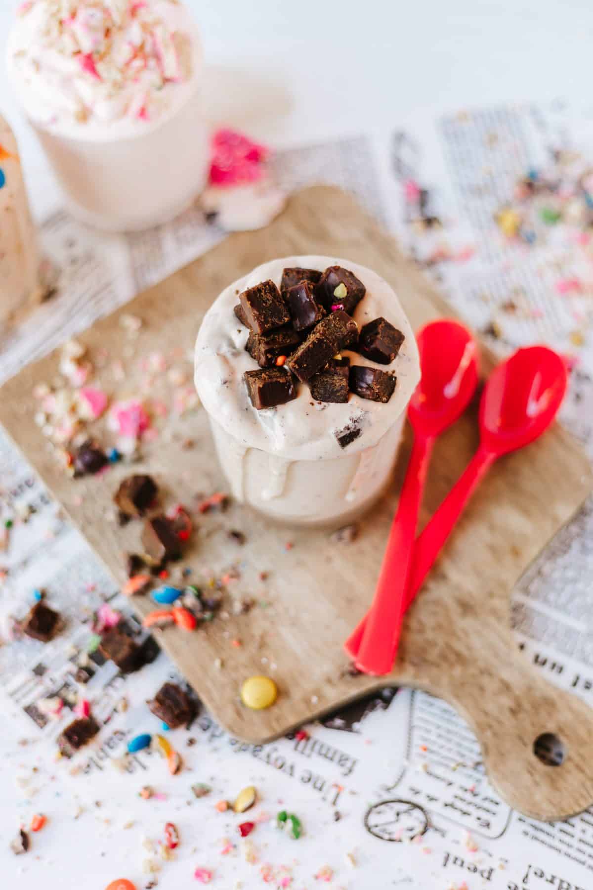 homemade blizzards on a wooden cutting board surrounded by candy pieces