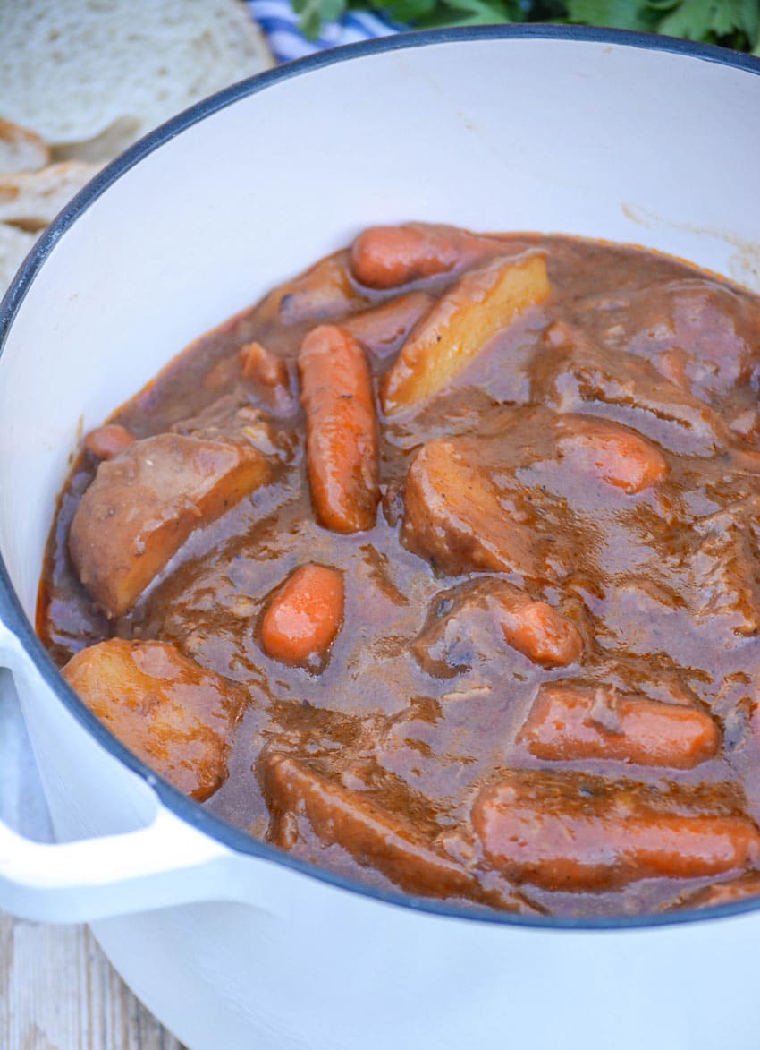 french onion beef stew in a small white dutch oven