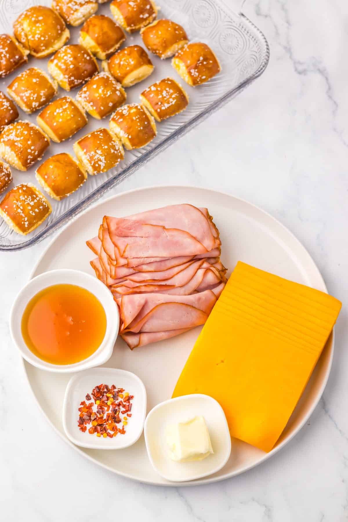 an overhead image showing the measured ingredients needed to make a batch of hot honey ham and cheese pretzel sliders