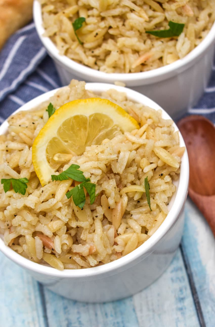 lemon rice in two small white bowls on a wooden table