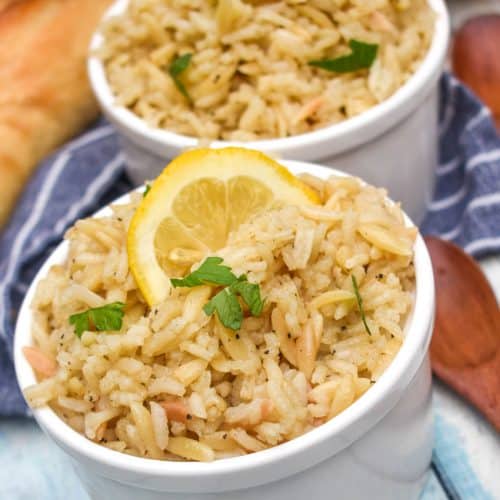 lemon rice in two small white bowls on a wooden table