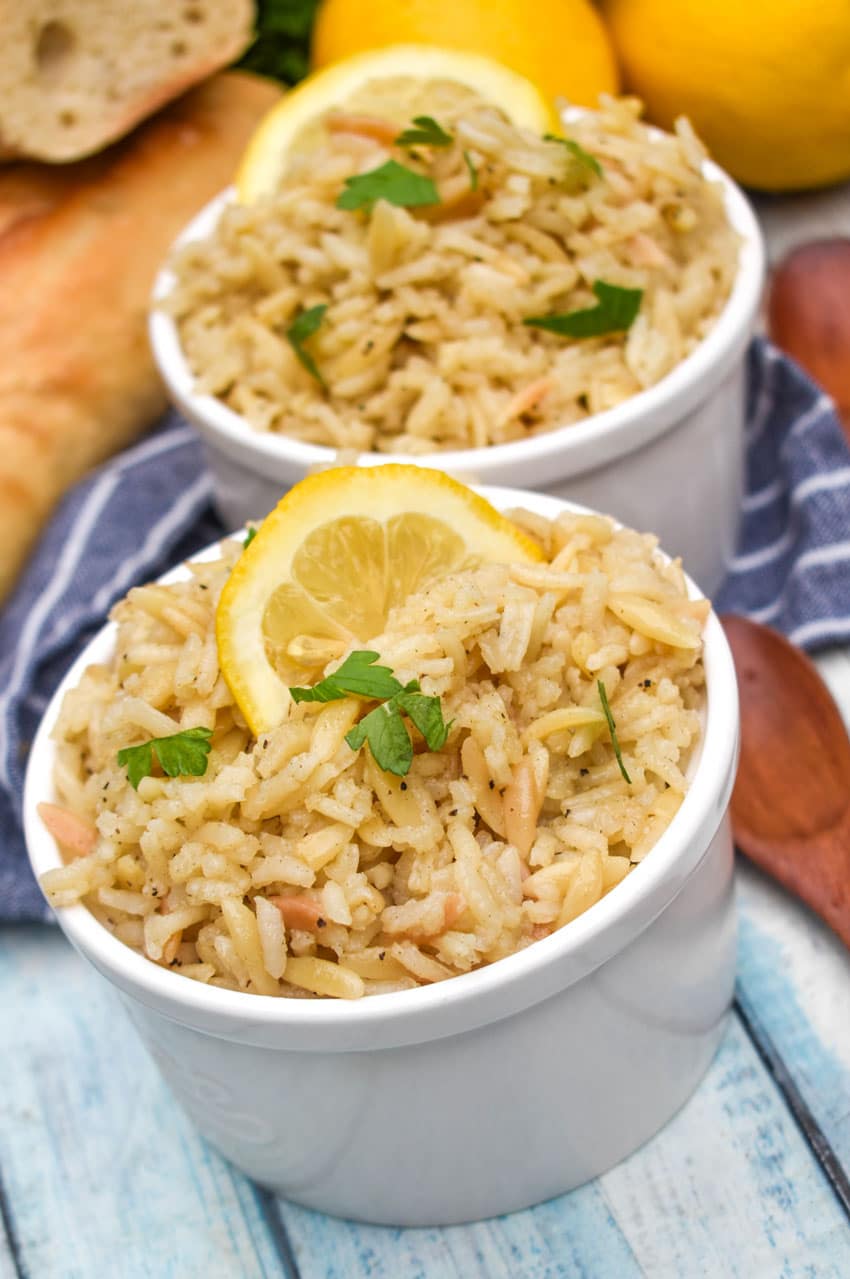 lemon rice in two small white bowls on a wooden table