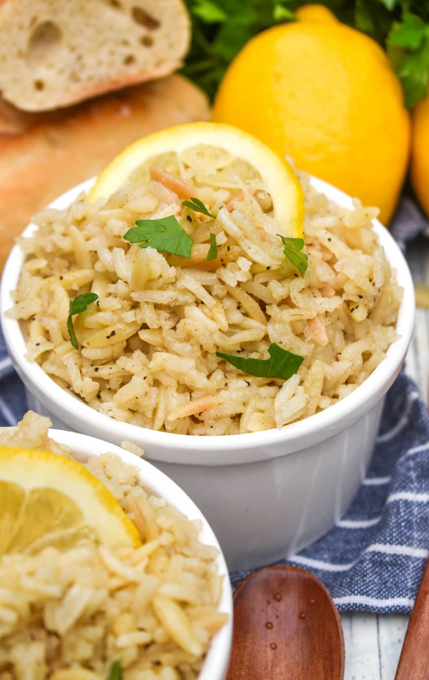 lemon rice in two small white bowls on a wooden table