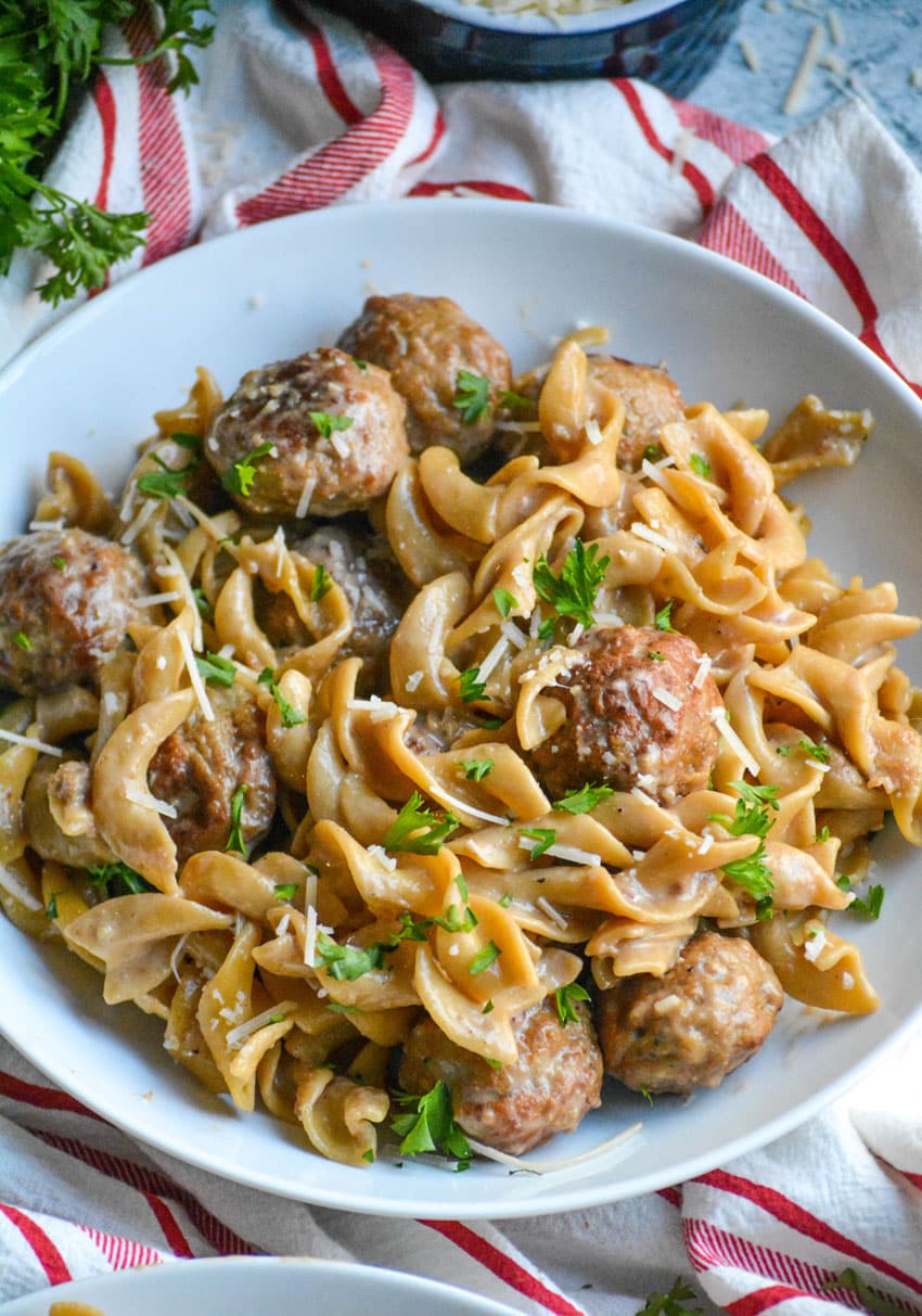 one pot swedish meatball topped with fresh herbs in a shallow white bowl