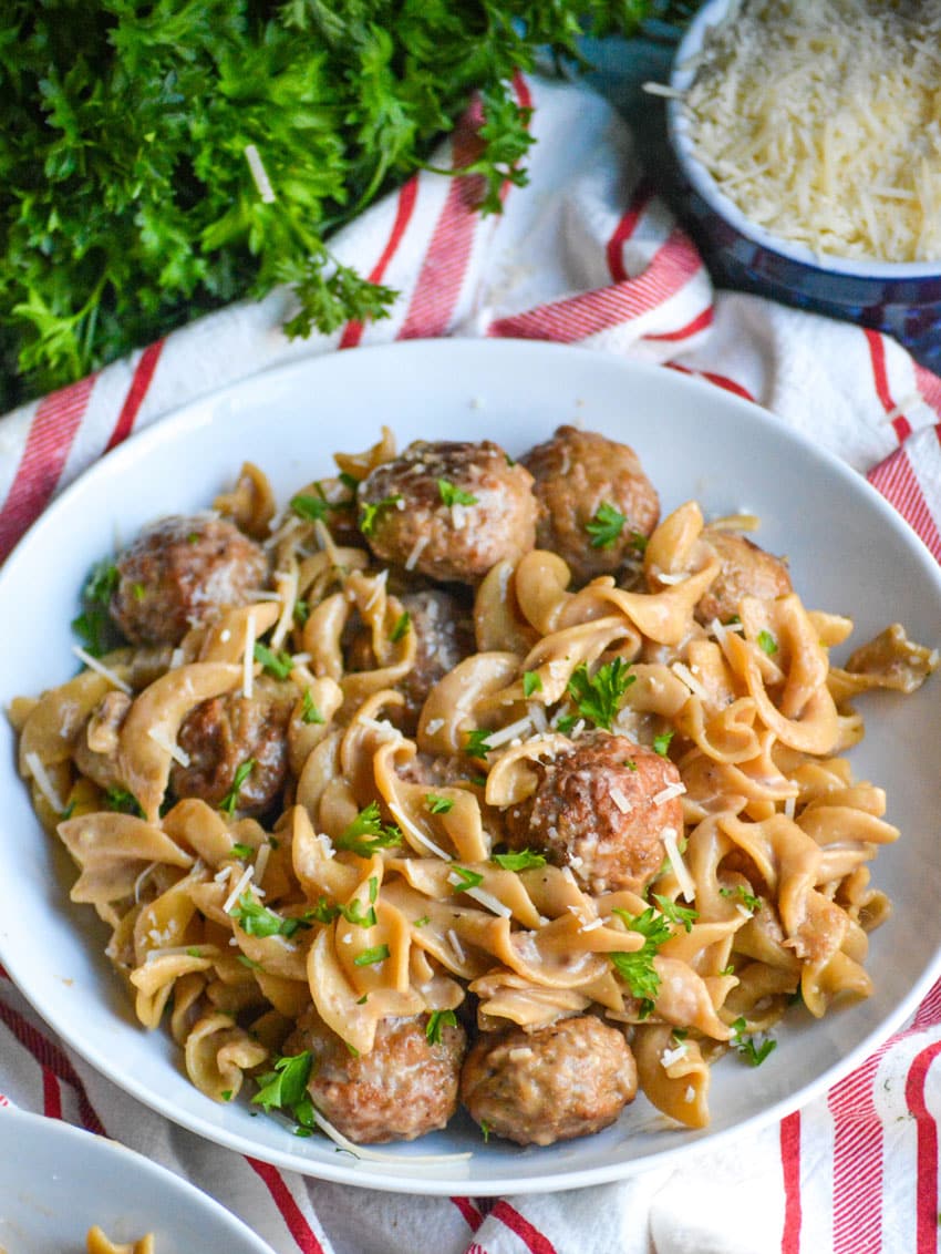 one pot swedish meatball topped with fresh herbs in a shallow white bowl
