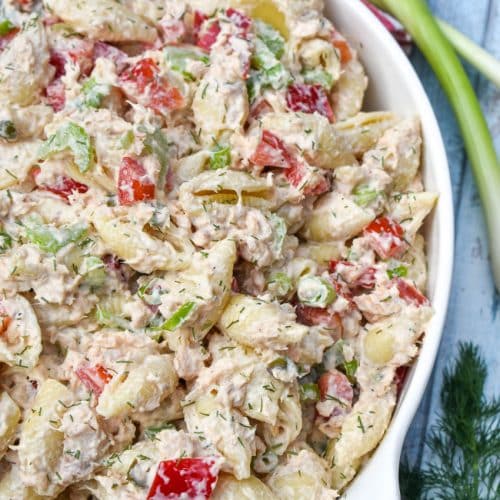 canned salmon pasta salad in a large white serving bowl