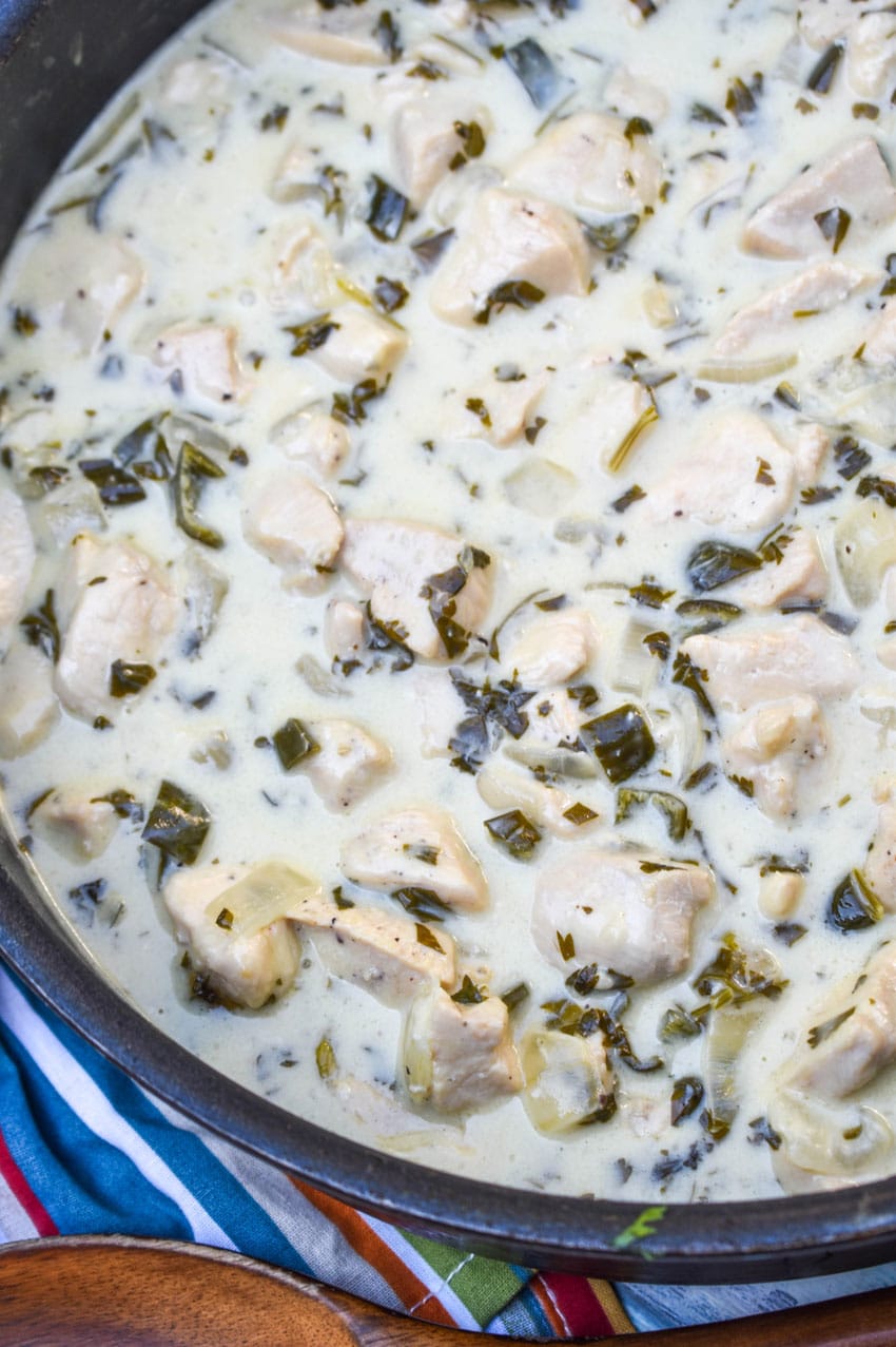 CREAMY POBLANO CHICKEN IN A LARGE BLACK SKILLET