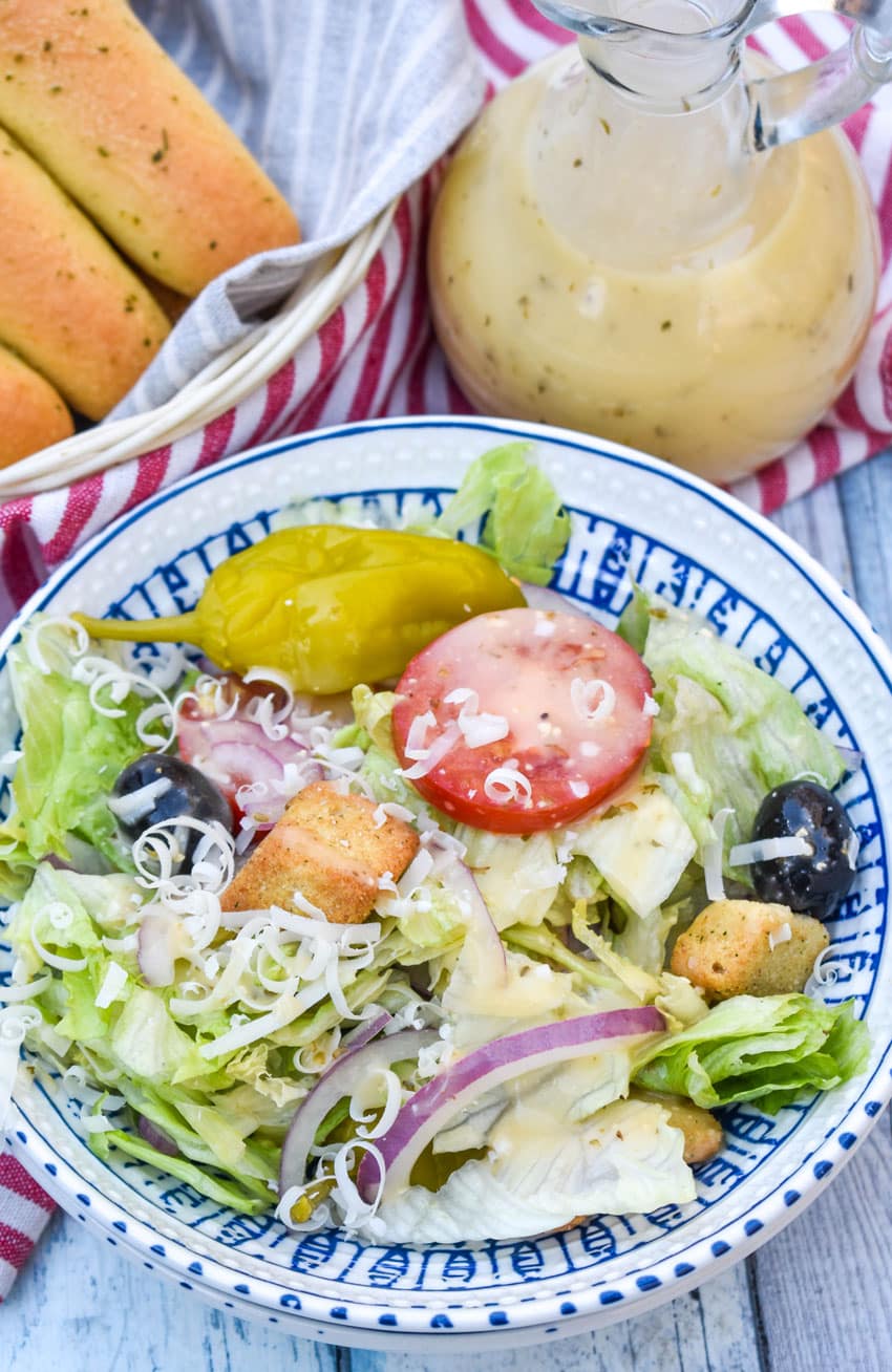 copycat olive garden salad in a blue and white bowl