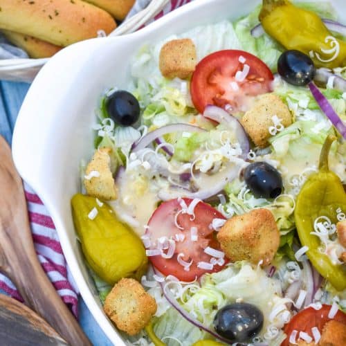 copycat olive garden salad in a white serving bowl