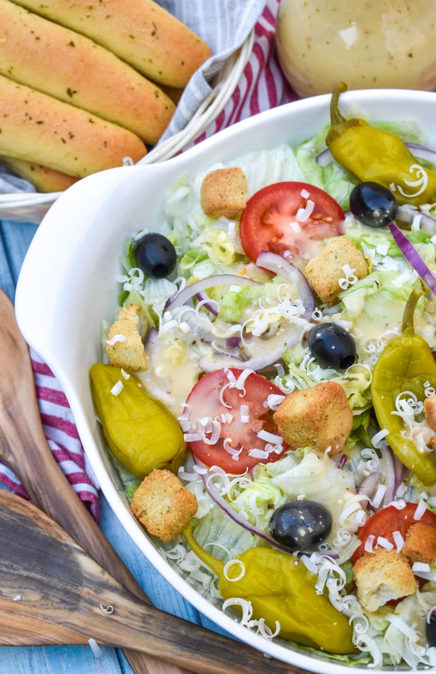 copycat olive garden salad in a white serving bowl