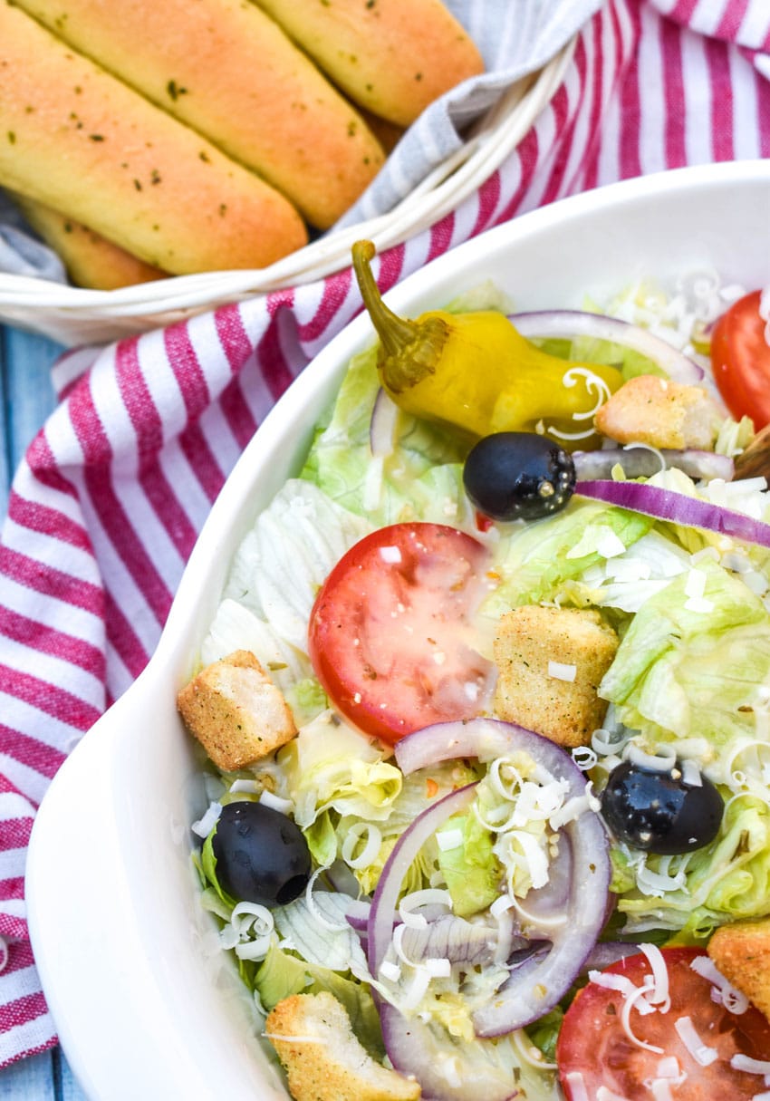 copycat olive garden salad in a white serving bowl