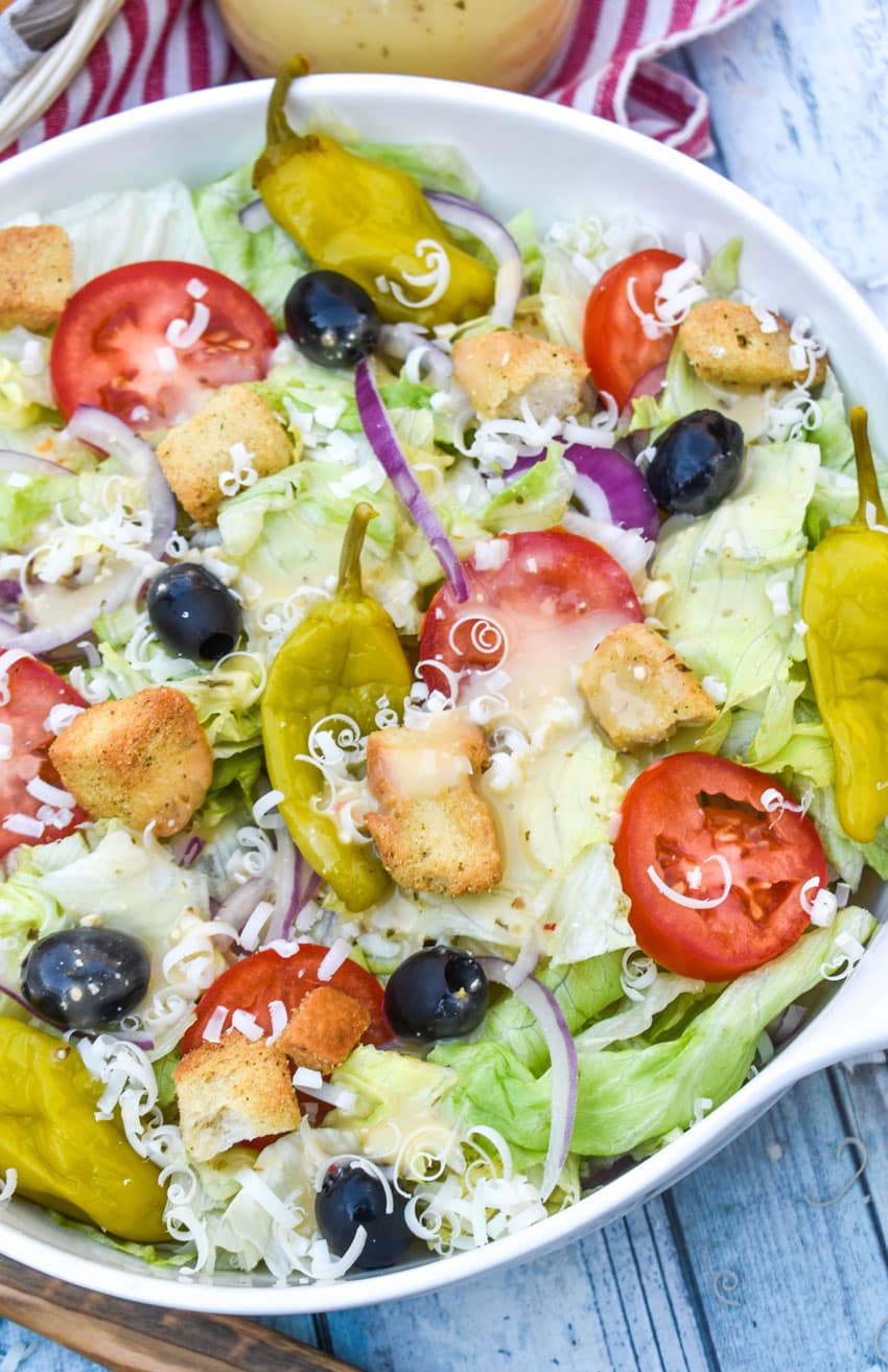 copycat olive garden salad in a white serving bowl