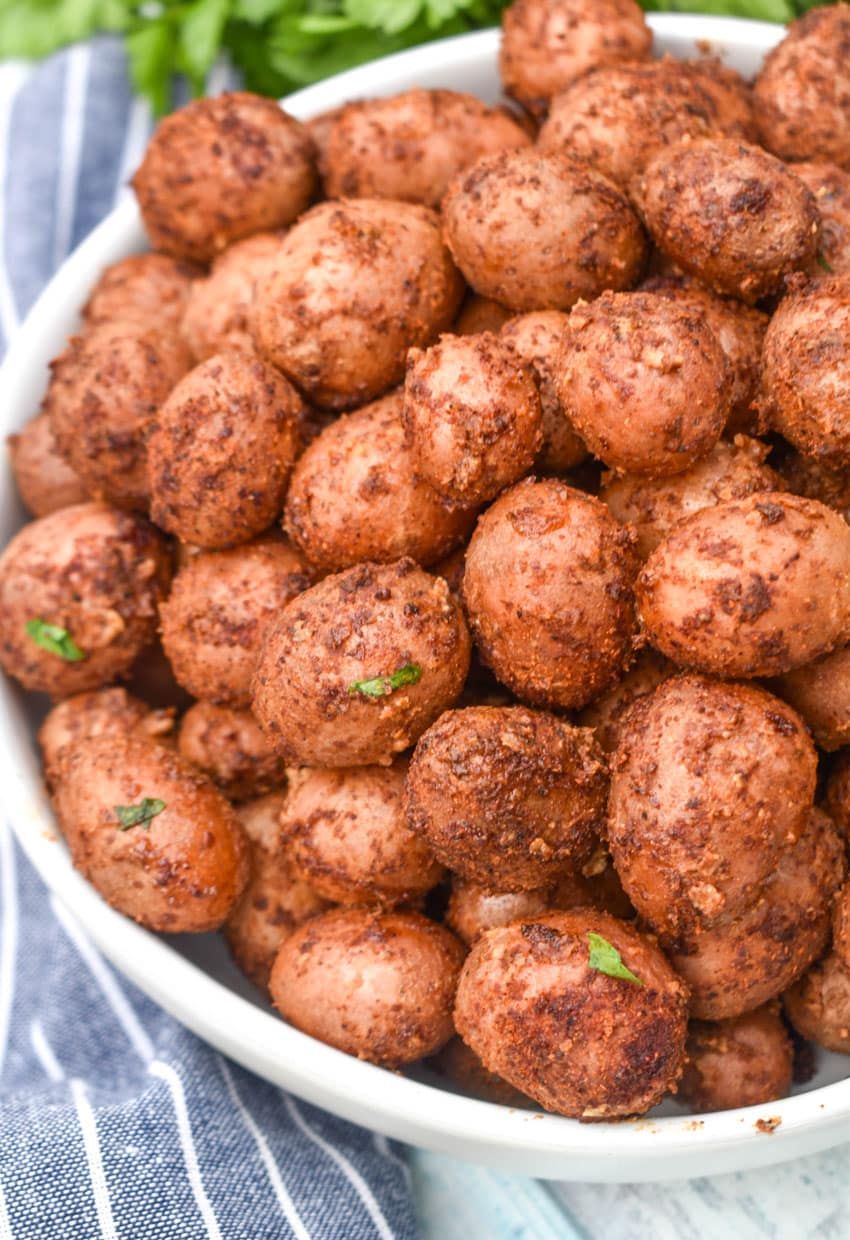 smoked baby potatoes in a small white serving bowl