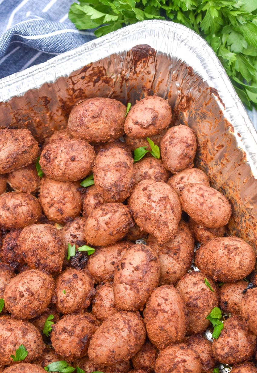 smoked baby potatoes in a disposable aluminum baking dish