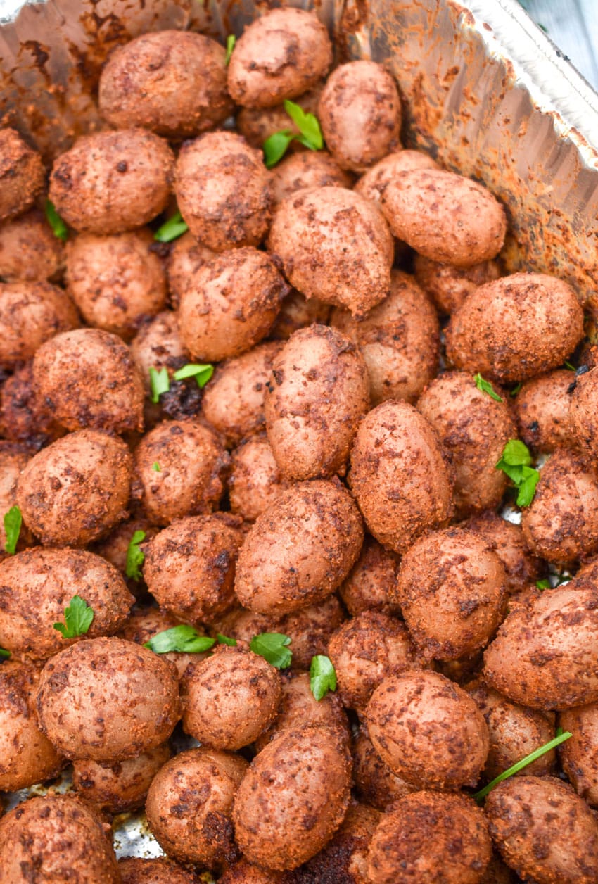 smoked baby potatoes in a disposable aluminum baking dish