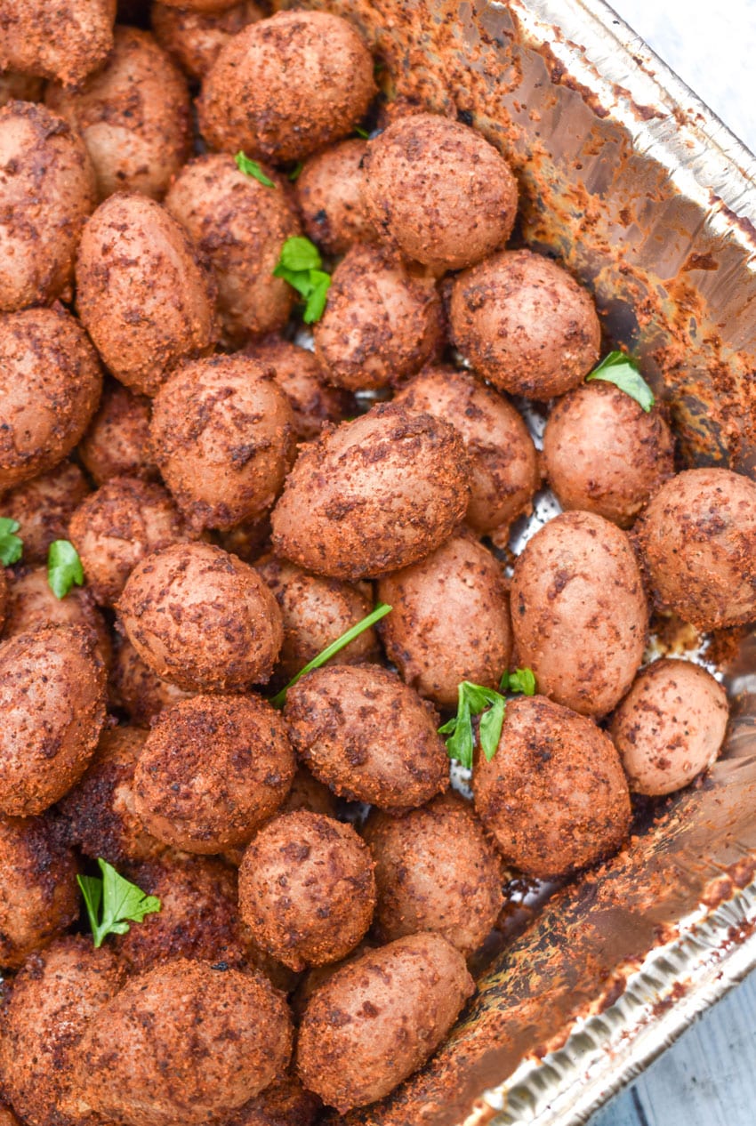 smoked baby potatoes in a disposable aluminum baking dish