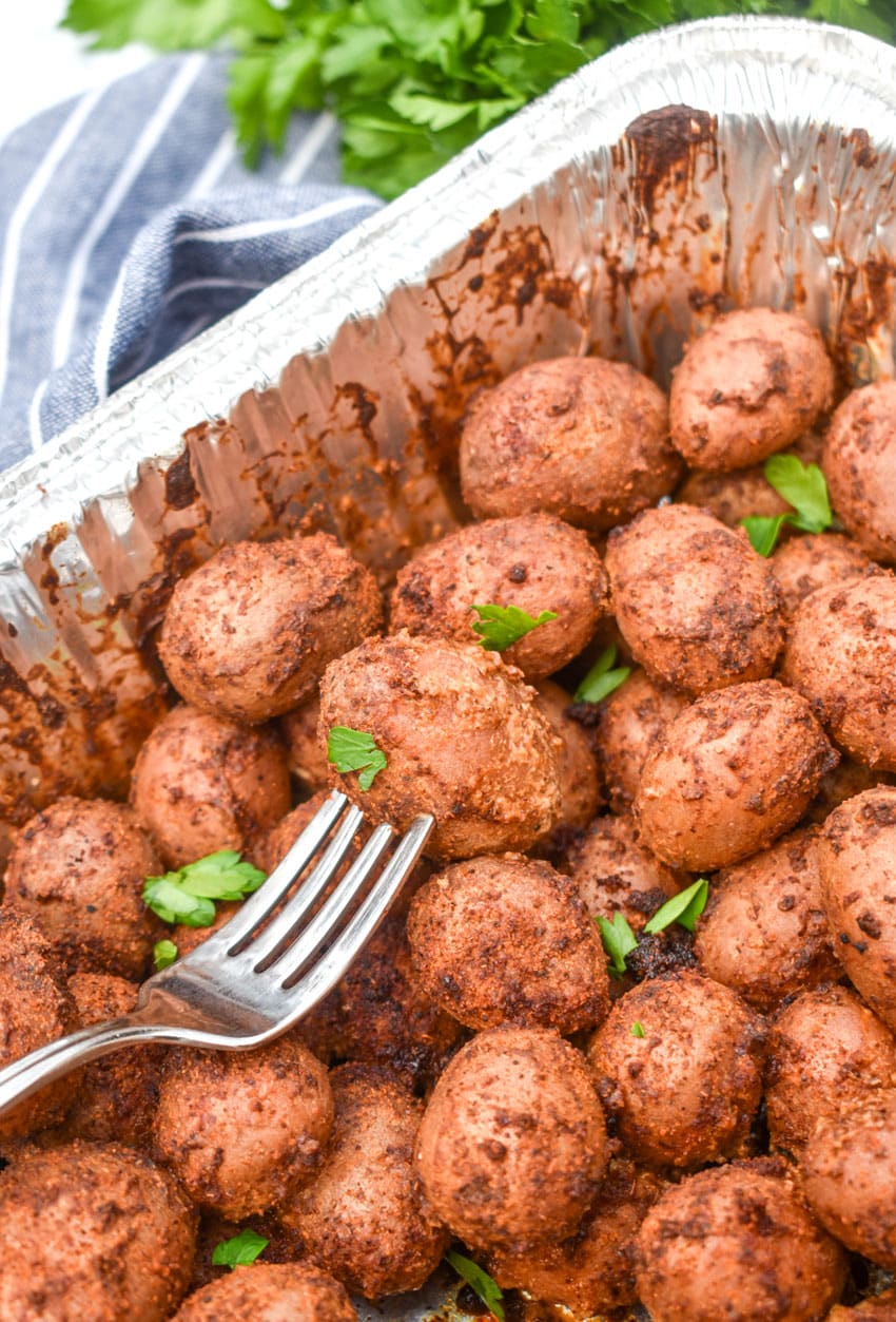 smoked baby potatoes in a disposable aluminum baking dish