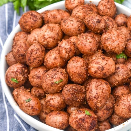 smoked baby potatoes in a small white serving bowl