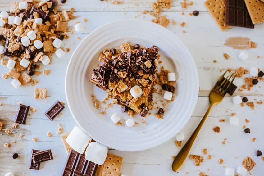 a slice of s'mores cookie cake on a small white dessert plate