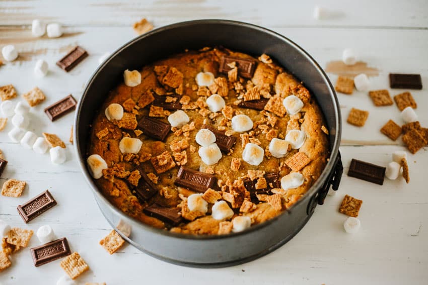a baked s'mores cookie cake in a metal springform pan