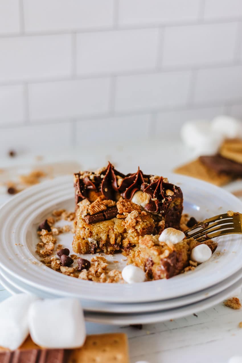 a slice of s'mores cookie cake on a small white dessert plate