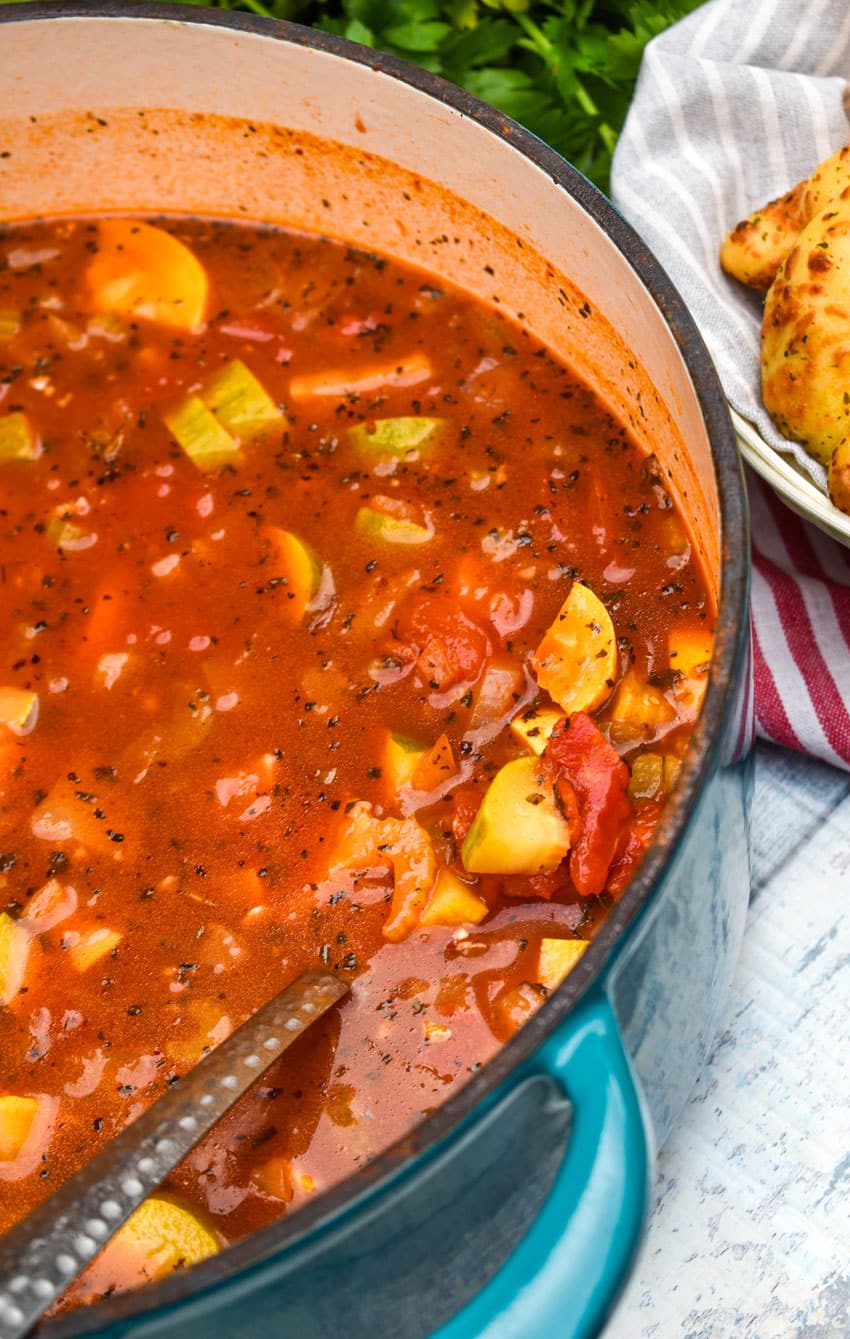 Italian summer soup in a large blue dutch oven