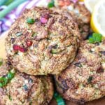 a stack of air fryer crab cakes on a wooden cutting board