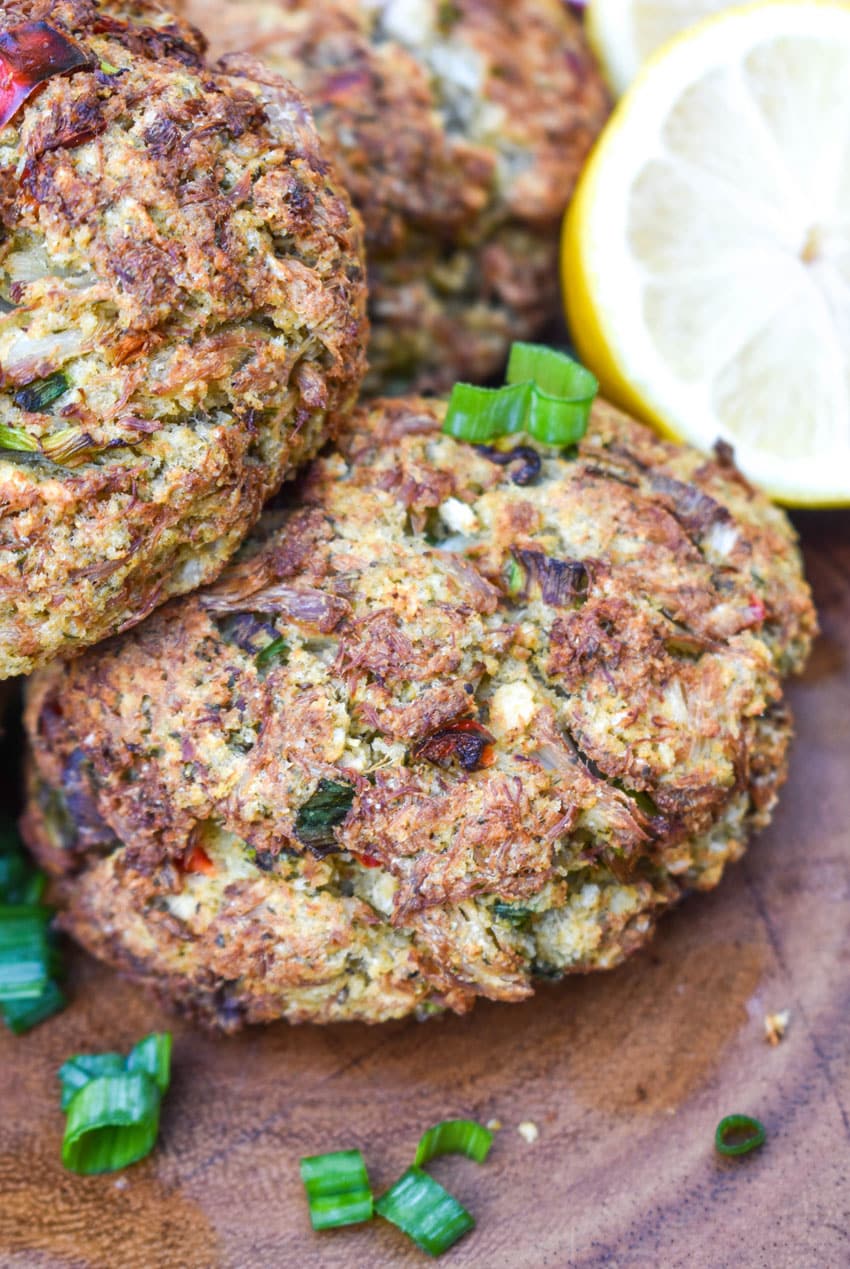 a close up of an air fried crab cake on a wooden cutting board