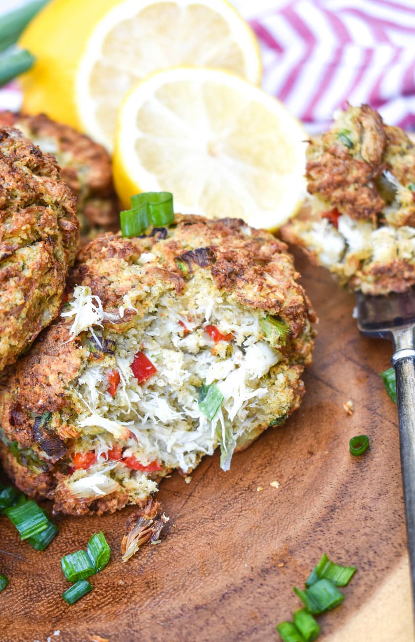 a close up of an air fried crab cake on a wooden cutting board